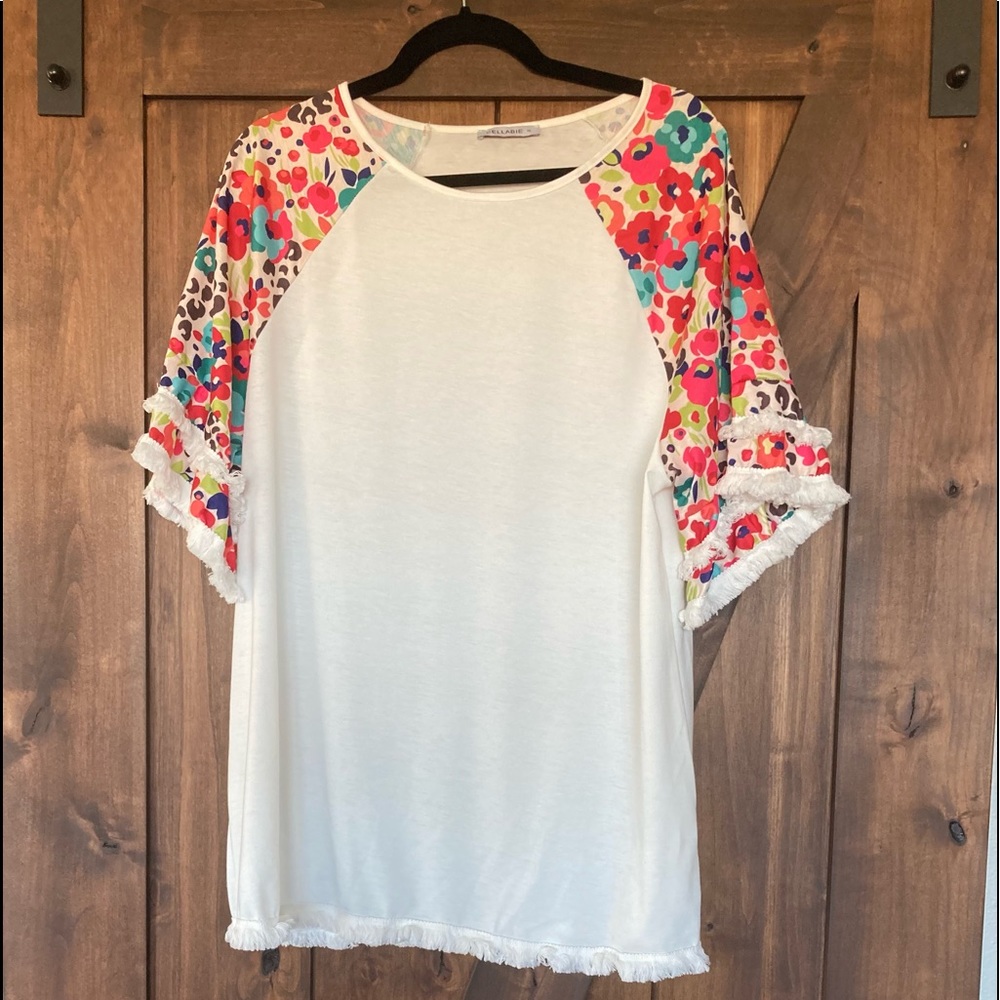Fun, breezy, colorful shirt with fringy hems!
